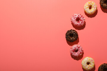Donuts on pink background, space for text