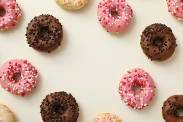 Fototapeta na wymiar Chocolate, white and pink donuts on white background, space for text