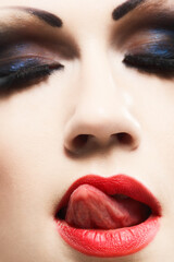 Naklejka premium Girl licking her lips. Conceptual image.
