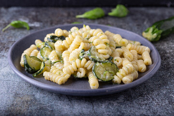 Fusilli pasta with zucchini and goat cheese cream. Healthy, balanced and nutritious vegetarian dish.