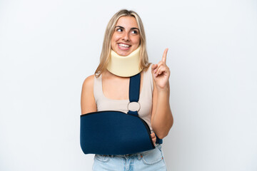 Woman with broken arm and wearing a sling isolated on white background pointing up a great idea