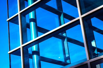 Abstract view of a corporate building with glass and steel, blue sky