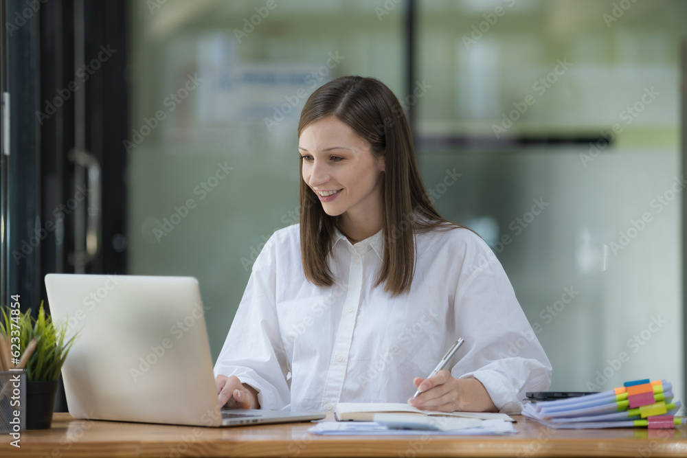 Poster a businesswoman or accountant using writing a notebook while working on an analytic business report 