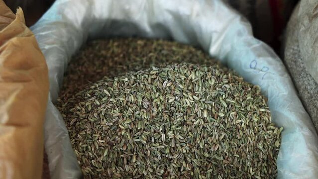 cumin seeds close up with black hand , organic fresh natural healthy food