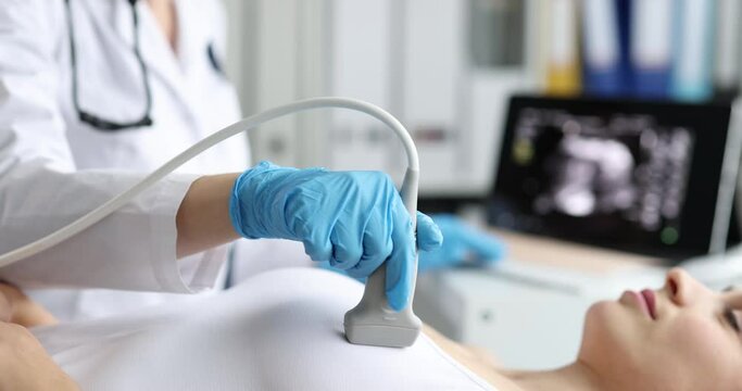 The doctor makes an ultrasound of the heart of a woman, a close-up of the chest. Re-examination, cardiovascular disease