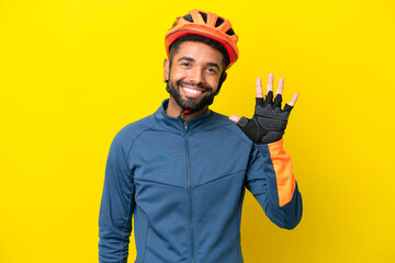 Young cyclist Brazilian man isolated on yellow background counting five with fingers