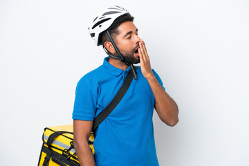 Young Brazilian man with thermal backpack isolated on white background yawning and covering wide open mouth with hand