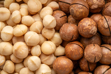 Roasted Macadamia nut in wooden plate on wooden background.