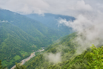 Mountain view with clouds over the river at the Machakhela national park