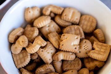 A portrait of multiple delicious letter, alphabet or abc cookies lying in a bowl ready to be eaten. A typical sweet snack popular in Belgium during Saint Nicholas in December.