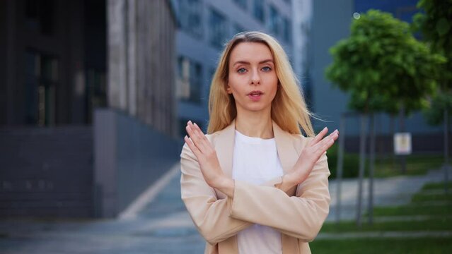 Girl crosses her arms, looks into the camera, advises client to avoid it and not make mistakes. Powerful assertive message promoting client caution and error prevention, loss of money or bankruptcy.