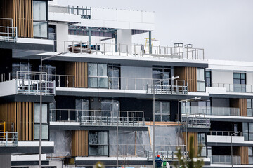 builders at the construction site of a suburban residential complex in winter