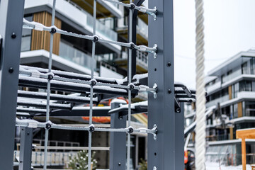 fragment of a street sports exercise machine against the backdrop of an elite residential area