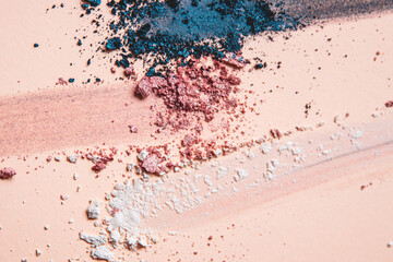 Fototapeta na wymiar Loose Crumbled Shimmer Eyeshadow Artistic Arrangement Teal, Pink and White on a Nude Shaded Background