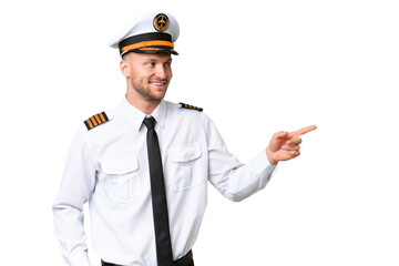 Airplane pilot man over isolated background pointing finger to the side and presenting a product