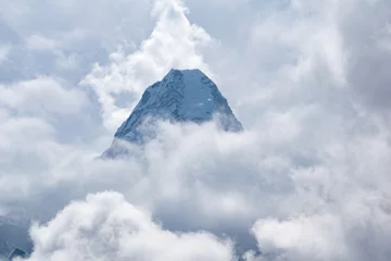 Photo sur Plexiglas Ama Dablam Cloud covered Ama Dablam is one of the most beautiful mountains in the world standing at an elevation of 6,812 metres (22,349 ft).Mother's necklace mountain peak seen at Ama Dablam base camp in Nepal.