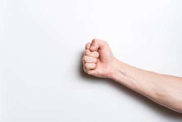 Close-up of a man's clenched fist on a white background.