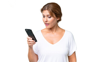 Fototapeta premium Middle-aged caucasian woman over isolated background sending a message or email with the mobile