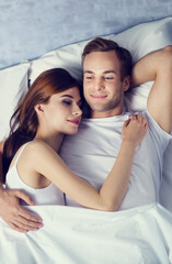 Portrait of happy couple on the bed at bedroom. Love, relationship, dating, bedtime, intimacy...