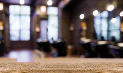 Barber shop background with blur, wooden table upfront. Empty space for decoration and advertising products.