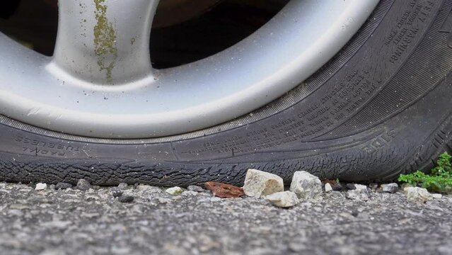 Flat tire of an old rusty car close up