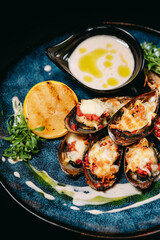 Fish dish baked New Zealand mussels on a blue plate