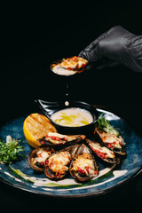 A baked New Zealand mussel in hand