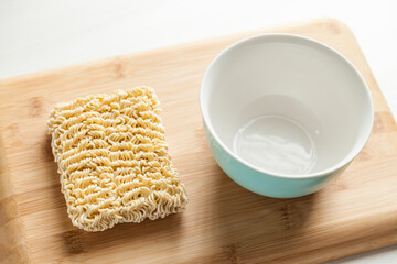 Ramen noodles on the table with a bowl and chopsticks. Ramen concept. Asian food concept.