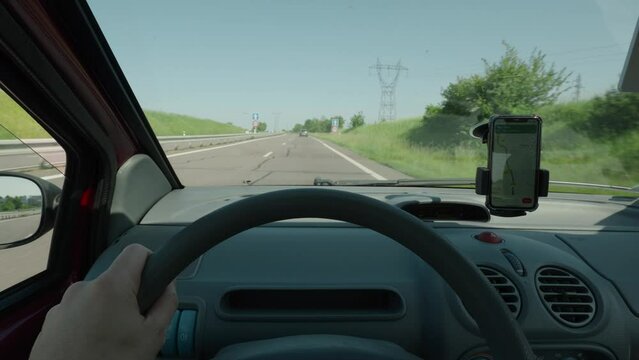 Driver Hands on Steering Wheel Driving Car, Sunny Highway GPS Phone Navigation on the Countryside at Summer