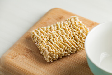 Ramen noodles on the table with a bowl and chopsticks. Ramen concept. Asian food concept.