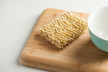 Ramen noodles on the table with a bowl and chopsticks. Ramen concept. Asian food concept.