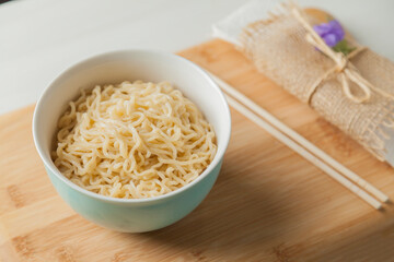 Ramen noodles in a bowl and chopsticks. Ramen concept. Noodle concept.
