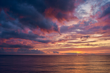 Naklejka na ściany i meble sunset with dramatic clouds over the sea