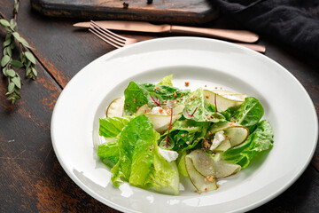Summer green salad with pears, nuts and cottage cheese. Diet dish for vegans, closeup