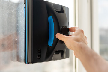 The white robotic window cleaner uses a brush and vacuum for a thorough cleaning. The automatic window washer is a great help for housekeeping tasks.