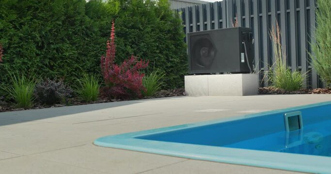 A small swimming pool, next to it is visible a heat pump for heating water. Energy Saving Technologies
