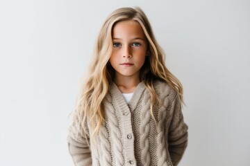 Fototapeta premium Lifestyle portrait photography of a glad kid female wearing a chic cardigan against a white background. With generative AI technology
