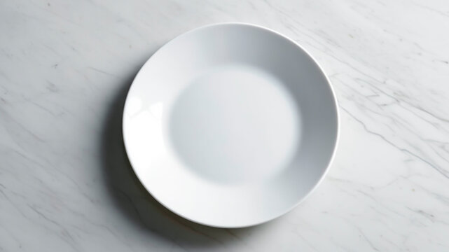 Empty white plate on white marble table.
