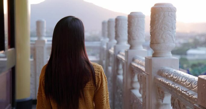 Woman go BaoHu Dimu Temple at Puli of Nantou of Taiwan in the evening