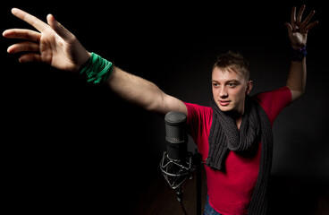 Photo of handsome guy with microphone in hands