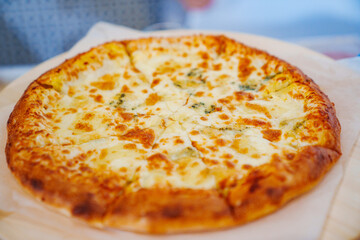 Appetizing cheese pizza. A dish of Italian cuisine.
