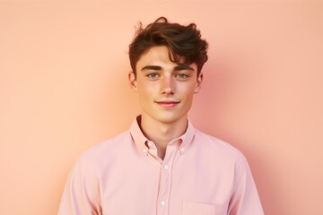 Fototapeta premium Headshot portrait photography of a glad boy in his 20s wearing a casual short-sleeve shirt against a peachy pink background. With generative AI technology