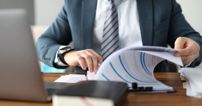Businessman in suit filling out documents at table in office closeup 4k movie. Health insurance concept