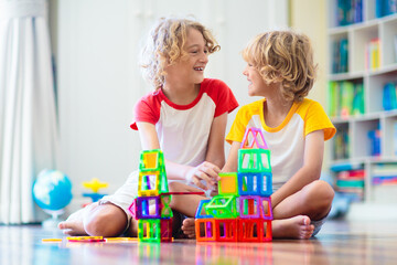 Child playing with magnetic building blocks.