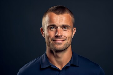 Obraz premium Close-up portrait photography of a satisfied boy in his 30s wearing a sporty polo shirt against a navy blue background. With generative AI technology