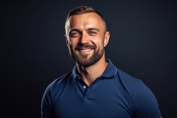Fototapeta premium Close-up portrait photography of a satisfied boy in his 30s wearing a sporty polo shirt against a navy blue background. With generative AI technology