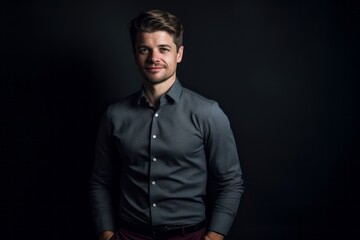 Obraz premium Lifestyle portrait photography of a glad boy in his 30s wearing an elegant long-sleeve shirt against a matte black background. With generative AI technology
