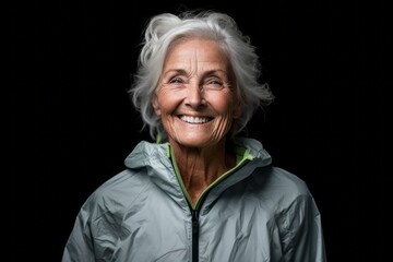Medium shot portrait photography of a happy mature woman wearing a lightweight windbreaker against a matte black background. With generative AI technology