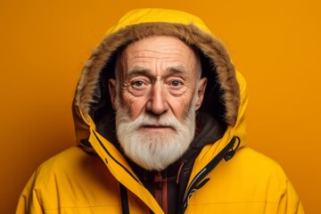 Close-up portrait photography of a glad old man wearing a warm parka against a bright yellow background. With generative AI technology