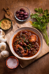 stewed polyps with tomato sauce black olives capers and parsley